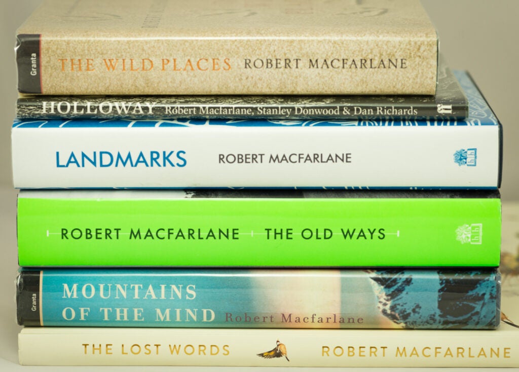 Pile of books authored by Robert MacFarlane: The Wild Places, Holloway, Landmarks, The Old Ways, Mountains of the Mind, The Lost Words