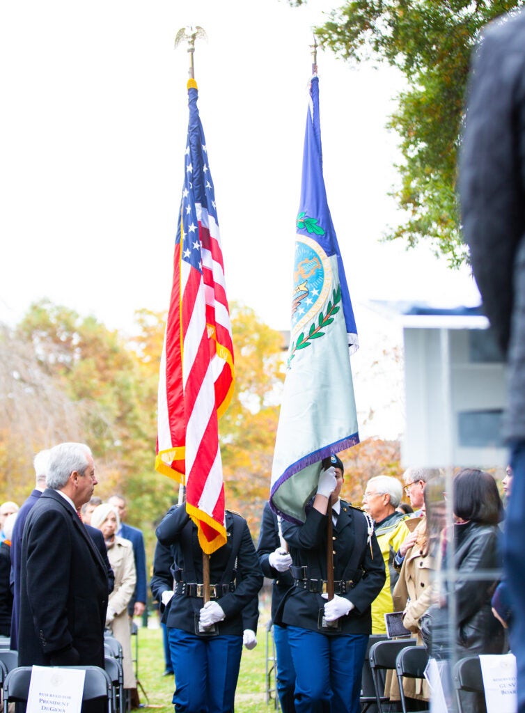 Veteran's Day Event. One military is uniform holds US flag, the other one holds the US Air Force Retired Flag