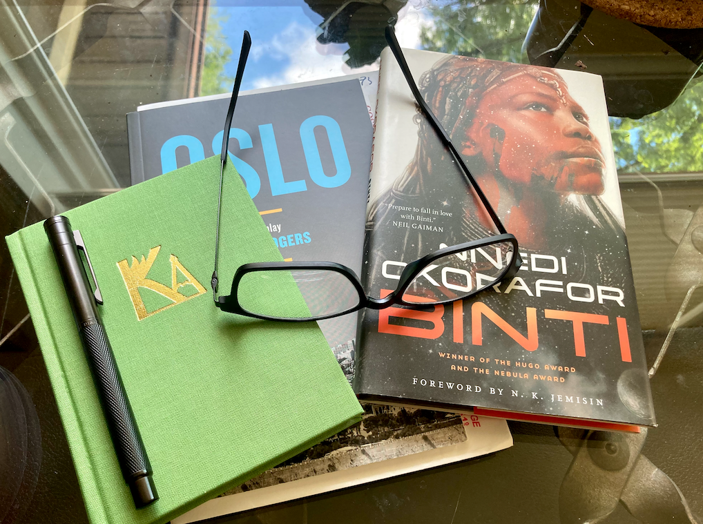 Book covers of Nnedi Okorafor's Binti, J.T. Rogers' Oslo and a book by Kallion