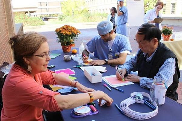 Artist, patient and medical professional doing handcrafts using kingsland cards