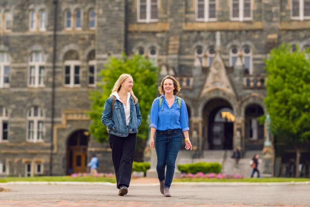 two students walking away from Healy Hall