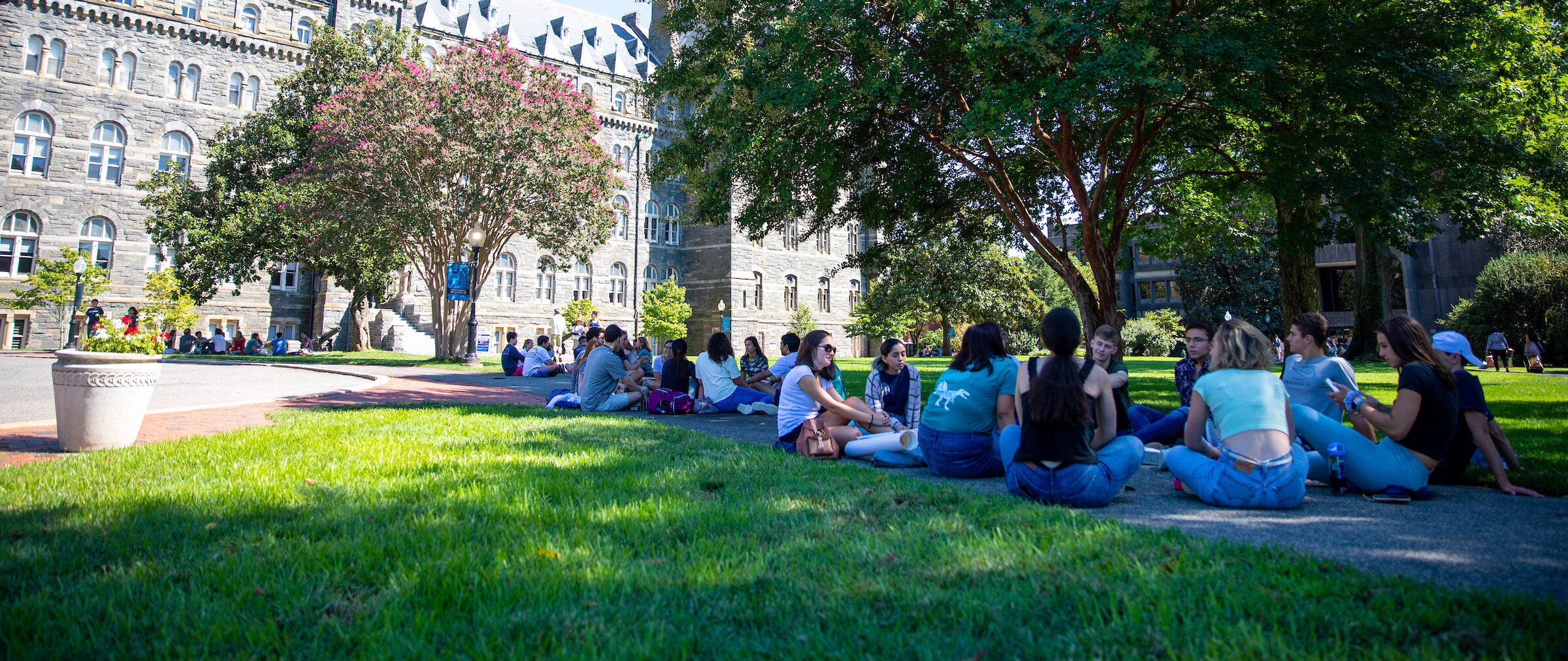 Humanities grad students sitting on Healy Lawn at Georgetown University