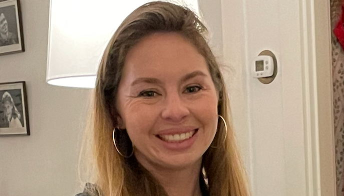 Headshot of Maddie Vahey in a black shirt