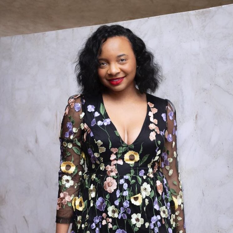 Chanel Williams smiles in a fancy floral dress